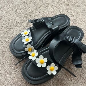 Black platform sandals with daisies